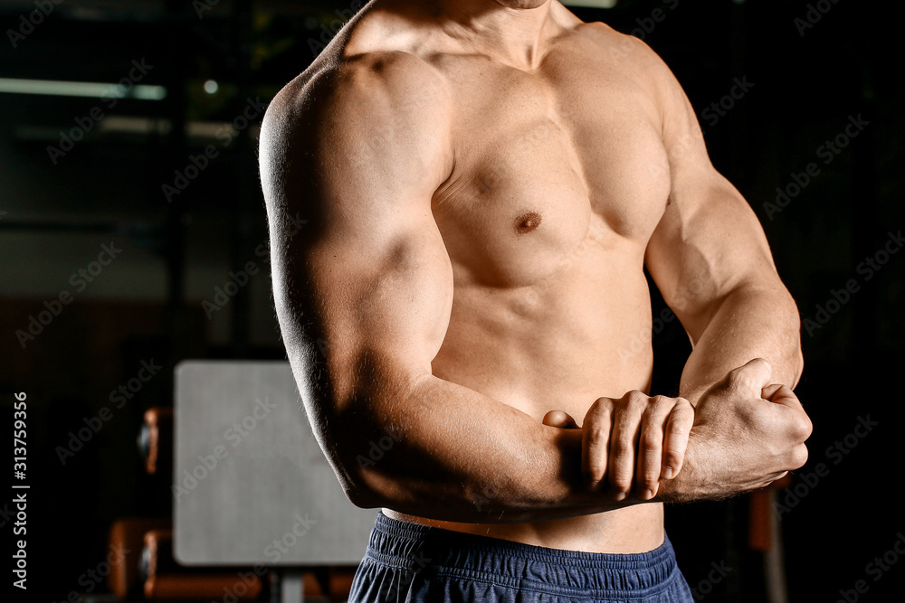 Sporty muscular man in gym