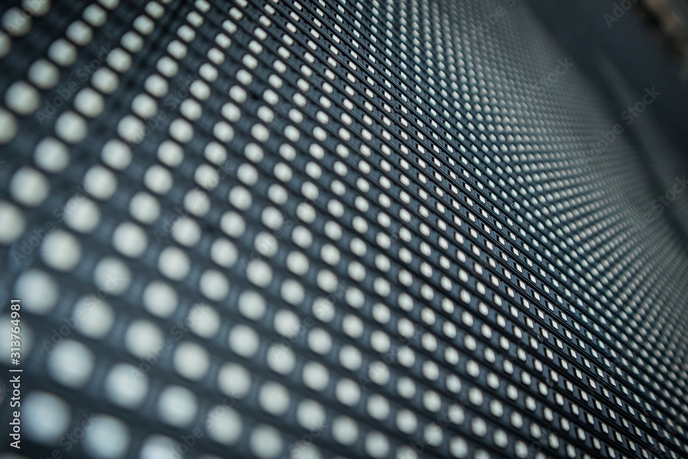Detail of a LED or LCD panel for screen on concerts or different displays. Focus on a centre row of LED lights, others in soft focus. Array of LED RGB lights for HD outdoor displays. Detail of a LED or LCD panel for screen on concerts or different displays. Focus on a centre row of LED lights, others in soft focus. Array of LED RGB lights for HD outdoor displays.