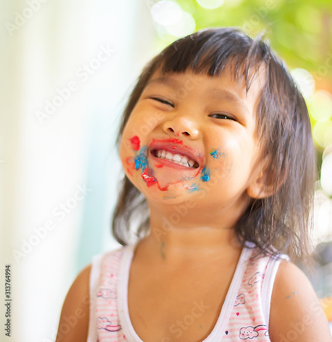 Face image of an Asian girl with a smile and fun.