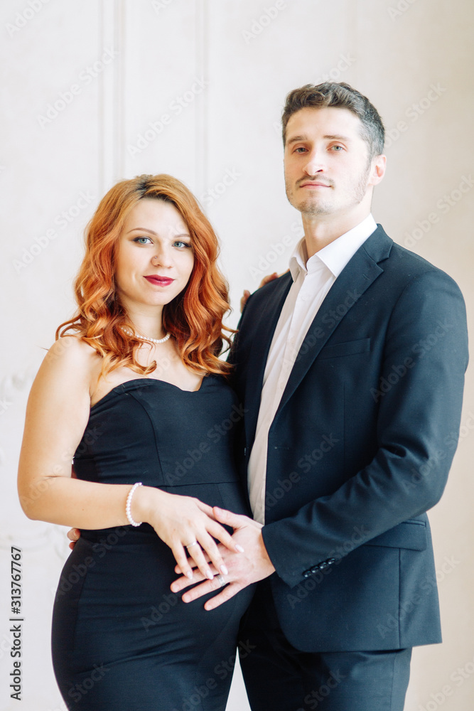 Family expecting a baby. Beautiful stylish couple in the Studio in evening images. Family expecting a baby. Beautiful stylish couple in the Studio in evening images.