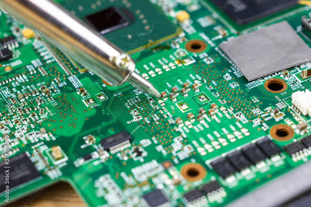 Technicians are using a soldering iron for repairing electronic of the computer circuit board concept technology of computer circuit hardware. Technicians are using a soldering iron for repairing electronic of the computer circuit board concept technology of computer circuit hardware.