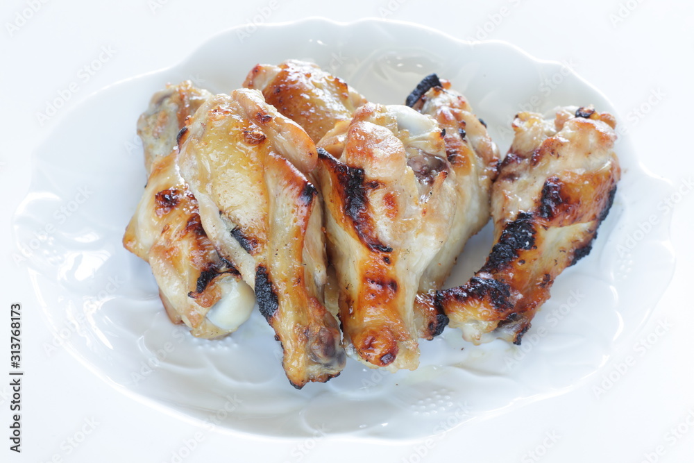 Asian chicken drumsticks barbecue on white dish