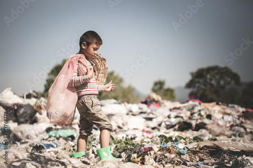 Poor children collect garbage for sale.and recycle them in landfills, the lives and lifestyles of the poor, Child labor, Poverty and Environment Concepts photo