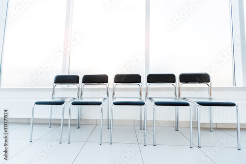 row of empty chairs in the office corridor
