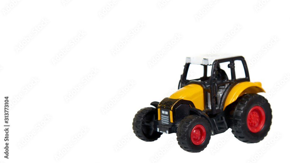 Yellow plastic traktor toy. Farming vehicle, harvest equipment. Yellow plastic traktor toy. Farming vehicle, harvest equipment.
