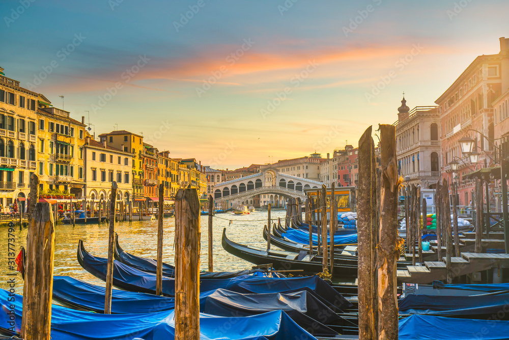 Venice grand canal, Rialto bridge at sunrise and gondolas. Italy