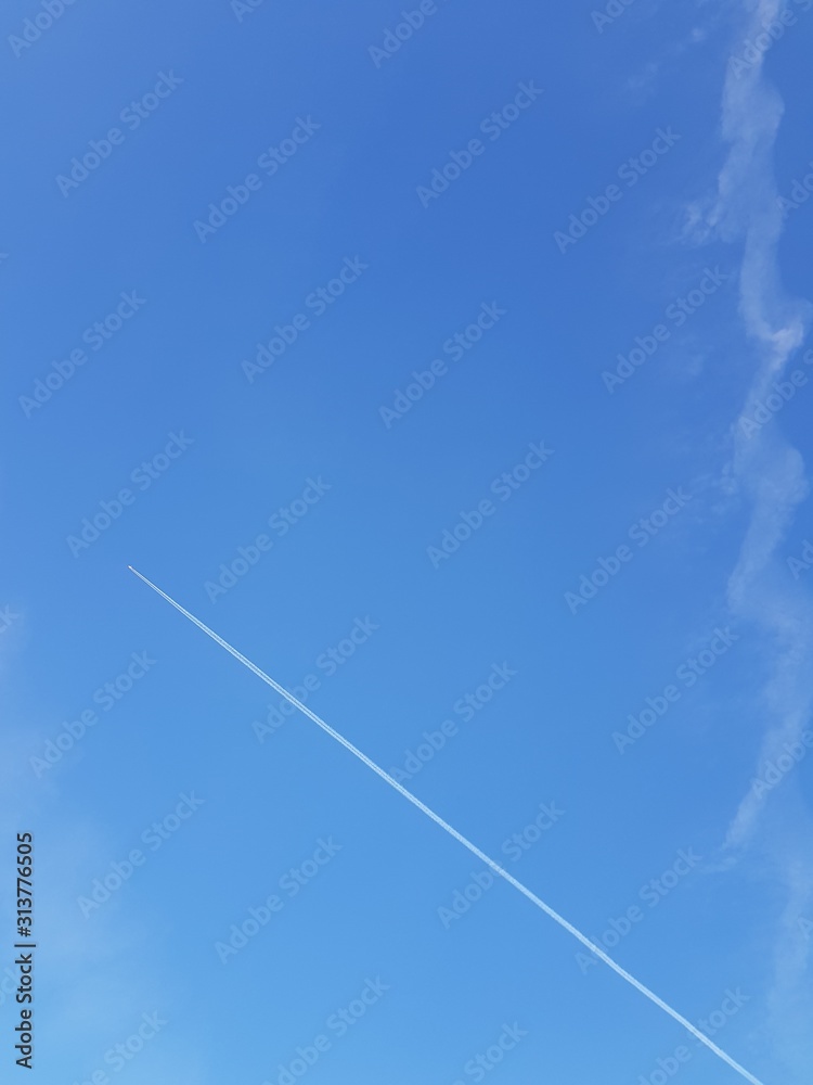 Inversion trail of an airplane in the sky Inversion trail of an airplane in the sky