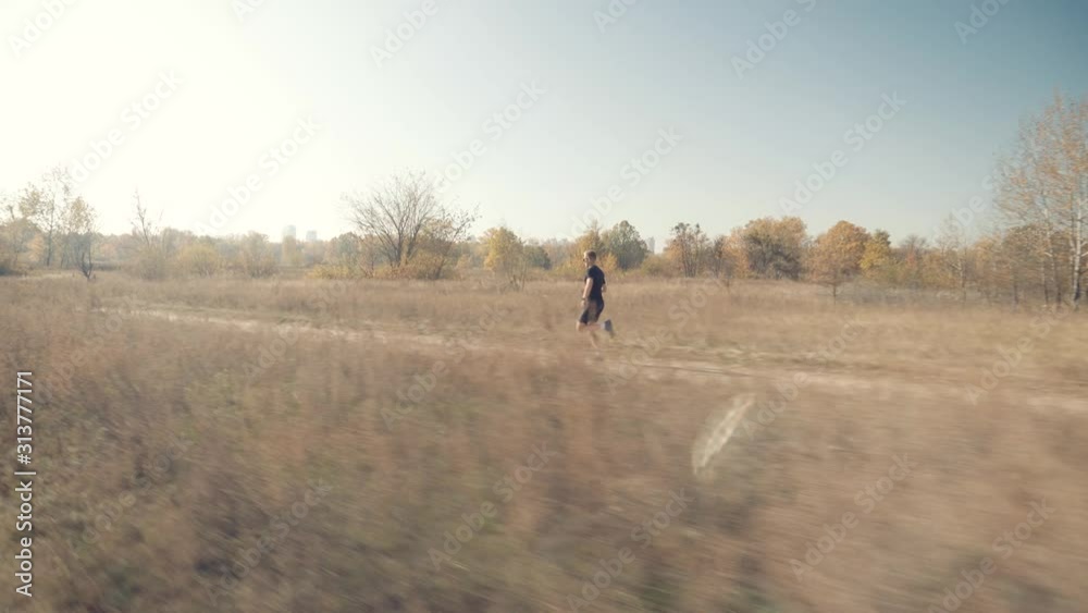 Running Man At Fall Park.Marathon Runner Jog On Trail.Runner Man Fit Athlete Legs Jogging On Trail Ready To Triathlon.Triathlete Running,Sprinting And Endurance Workout Training.Jogger Sport Concept Running Man At Fall Park.Marathon Runner Jog On Trail.Runner Man Fit Athlete Legs Jogging On Trail Ready To Triathlon.Triathlete Running,Sprinting And Endurance Workout Training.Jogger Sport Concept