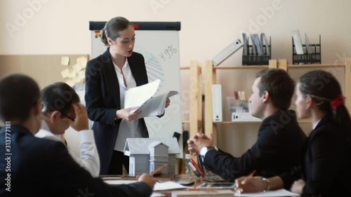Woman boss shows on papers poorly done work and loudly indignant photo