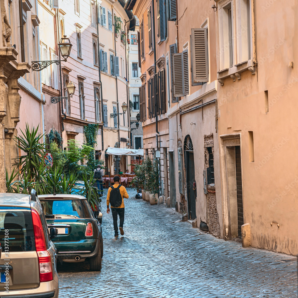 Rome, Italy - October 9, 2019 - typical narrow cobblestone street in the old part of the Italian capital