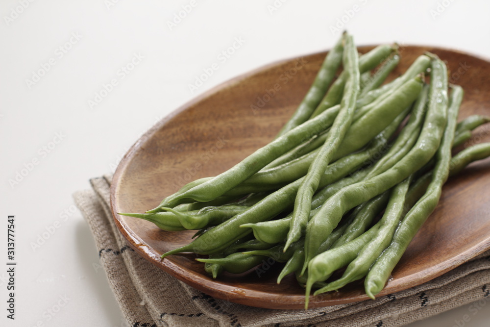 Freshness green bean on wooden plate for healthy food ingredient Freshness green bean on wooden plate for healthy food ingredient