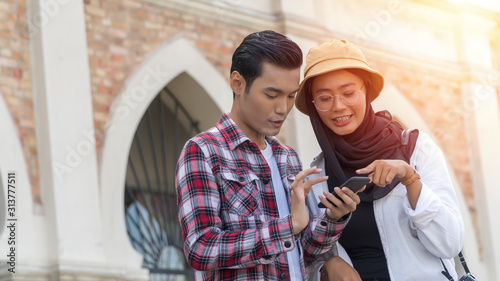 Photography Travel Concept, Muslim Tourist Couple at Kuala Lumpur