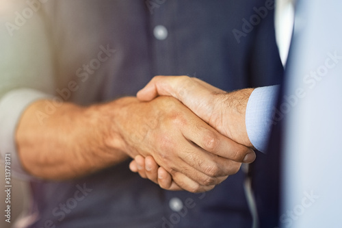 Close up of businessmen shaking hands photo