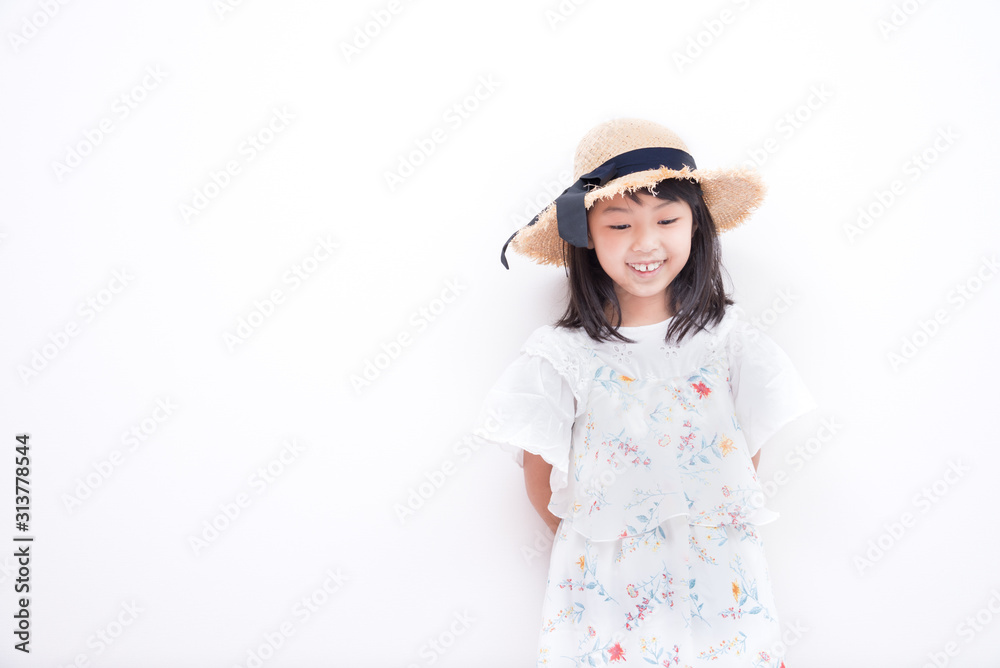 麦わら帽子を被ったお洒落な小学生の女の子 Photos Adobe Stock