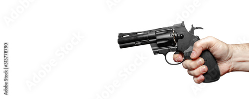 Male hand with a black revolver ready to shoot. The finger presses the trigger. Close-up. Isolate on a white background.