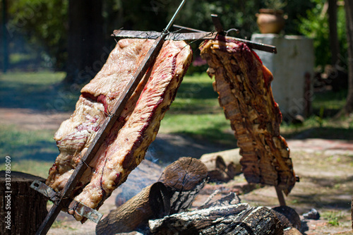 Asado, traditional barbecue dish in Argentina, roasted meat cooked on a crossed vertical grills