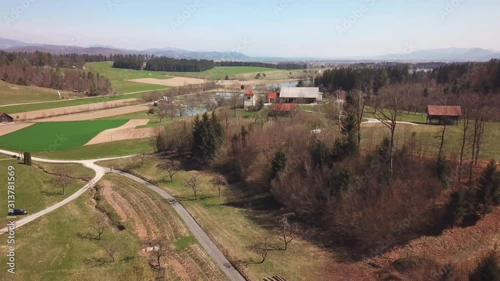 Aerial: Flying beside small countryside road going away from big pond. Filming wonderful Slovenian countryside nature on sunny autumn day. Aerial: Flying beside small countryside road going away from big pond. Filming wonderful Slovenian countryside nature on sunny autumn day.