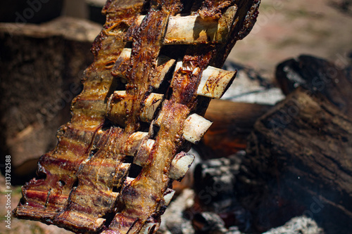 Asado, traditional barbecue dish in Argentina, roasted meat cooked on a crossed vertical grills