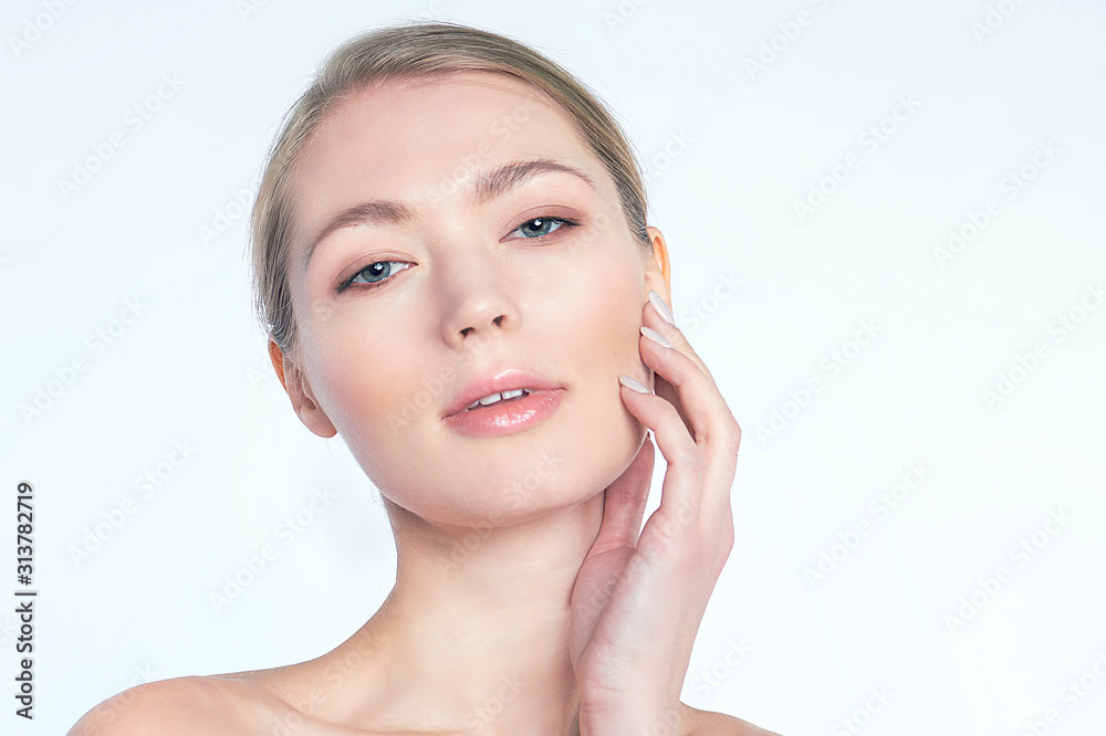face of beautiful woman pointing at her eye area. perfect skin