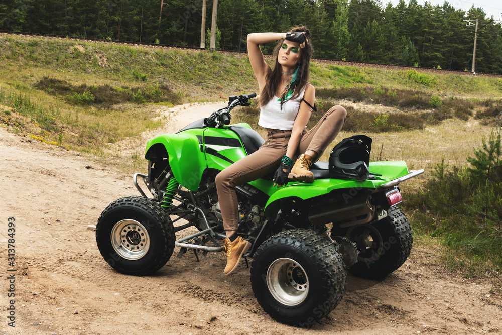 Stylish and beautiful woman and the ATV