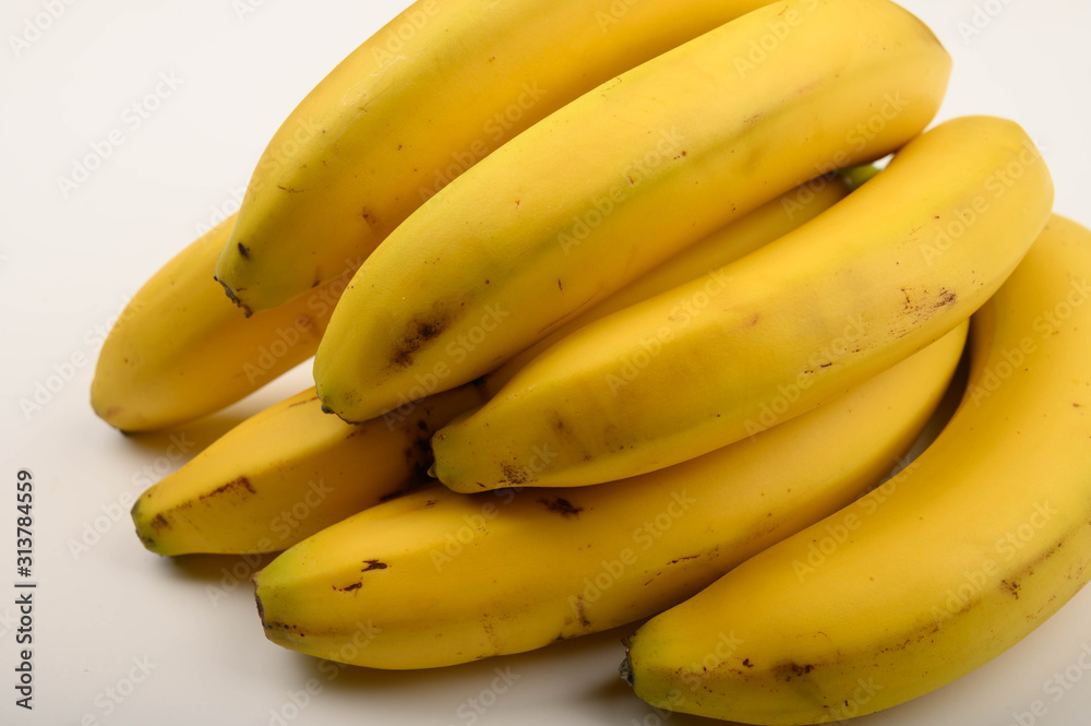 Bunch of ripe yellow bananas on a white background. Close up.