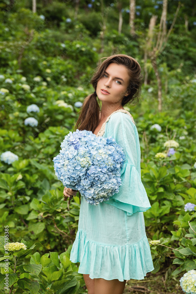 Young and beautiful woman florist collecting Hydrangea flowers Young and beautiful woman florist collecting Hydrangea flowers