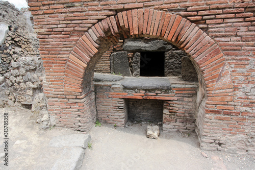 Masoned clay oven at the House of the Baker, the Casa del Forno, an ancient bakery at the ancient city of Pompeii, near Naples, Italy