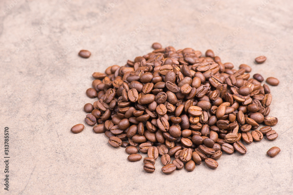 Coffee beans on a brown textured background, empty copy space Coffee beans on a brown textured background, empty copy space