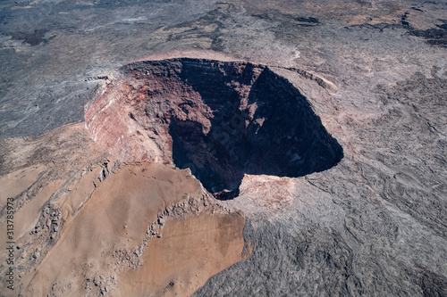 looking down from a helicopter at the volcanic crater rim on Big Island Hawaii