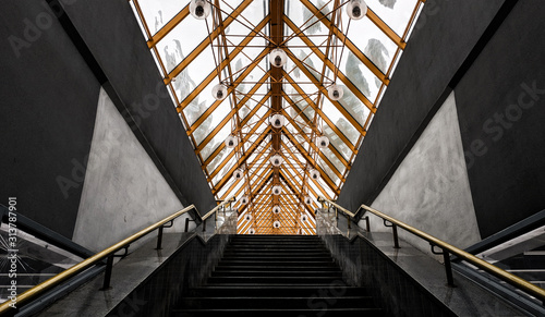 inside the architectural structure of the future with an interesting combination of black  white and yellow colors bridge over the river with a glass roof