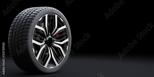Wheel with modern alu rim on black background photo