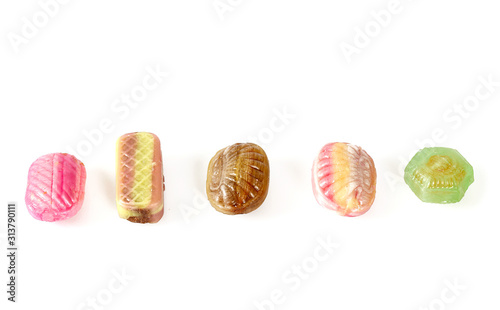 assortment of caramel candies isolated on white