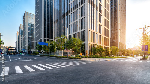 Fototapeta Naklejka Na Ścianę i Meble -  Road pavement and modern building in Jinan financial district