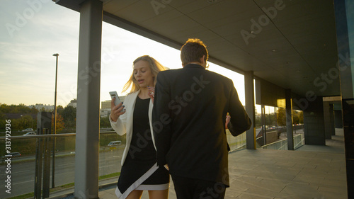 CLOSE UP: Inconsiderate yuppie crashes into young businesswoman walking home.