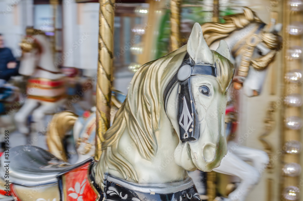 Novi Sad, Serbia - December 13. 2019: Downtown Novi Sad. The decorations on the children's carousel with wooden horses