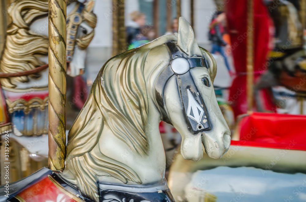 Novi Sad, Serbia - December 13. 2019: Downtown Novi Sad. The decorations on the children's carousel with wooden horses Novi Sad, Serbia - December 13. 2019: Downtown Novi Sad. The decorations on the children's carousel with wooden horses