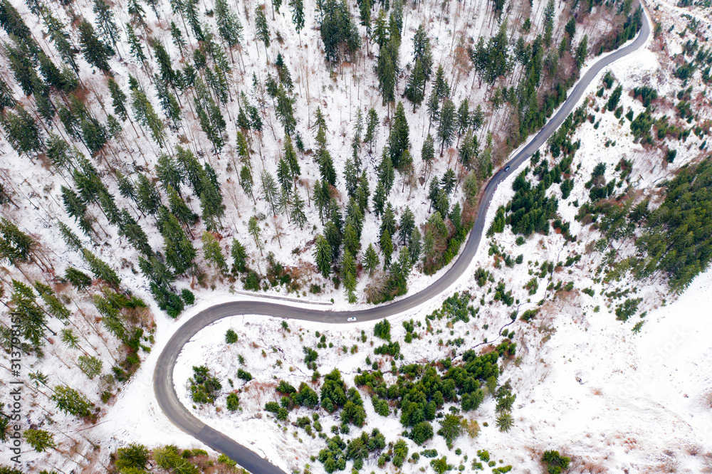 Snowy rural road aerial view.