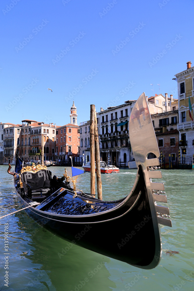 A gondola moored to the pier at the Grand Canal in Venice, Italy