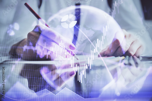 Wallpaper Mural A woman hands writing information about stock market in notepad. Forex chart holograms in front. Concept of research. Torontodigital.ca