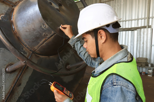 Mechanic engineer in factory checking quality of metals