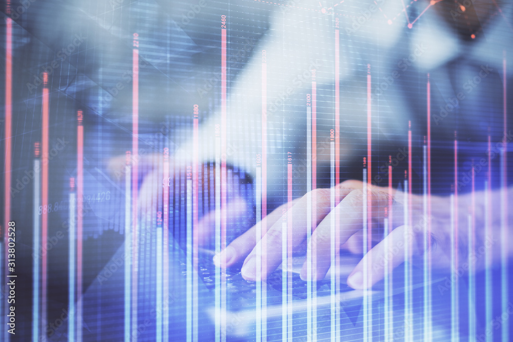 Forex graph with businessman typing on computer in office on background. Concept of analysis. Double exposure. Forex graph with businessman typing on computer in office on background. Concept of analysis. Double exposure.