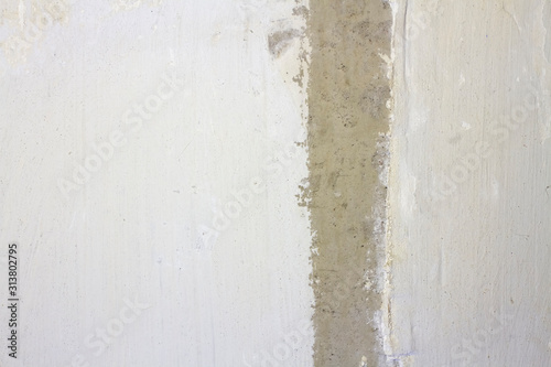 concrete wall with cement plaster with a strip in the middle