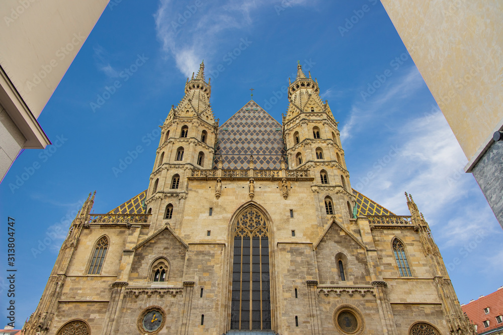 Vienna capital of Austria city center European medieval town sightseeing destination cathedral old architecture symmetry exterior facade foreshortening from below between concrete walls ob buildings