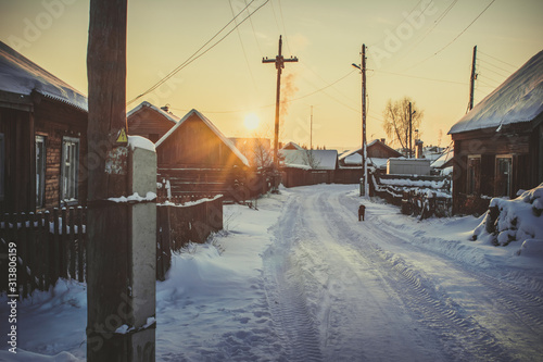 Siberian village in winter at sunset