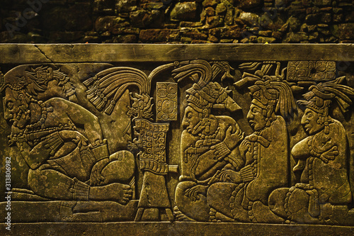 Ancient Mayan drawings on the stone wall photo