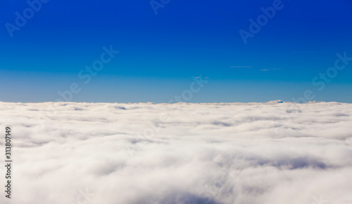 above the clouds view of blue sky background