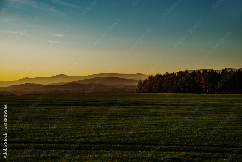 rising sun panorama of meadows and hills
