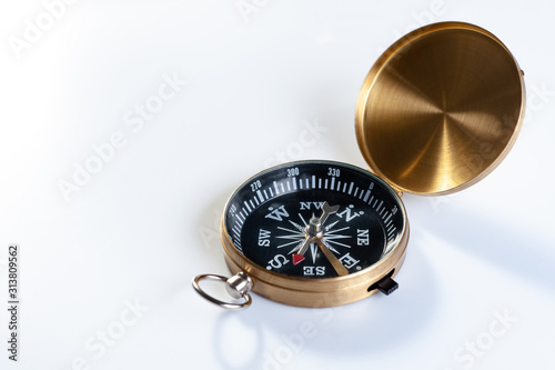  old compass of gold color on a white background