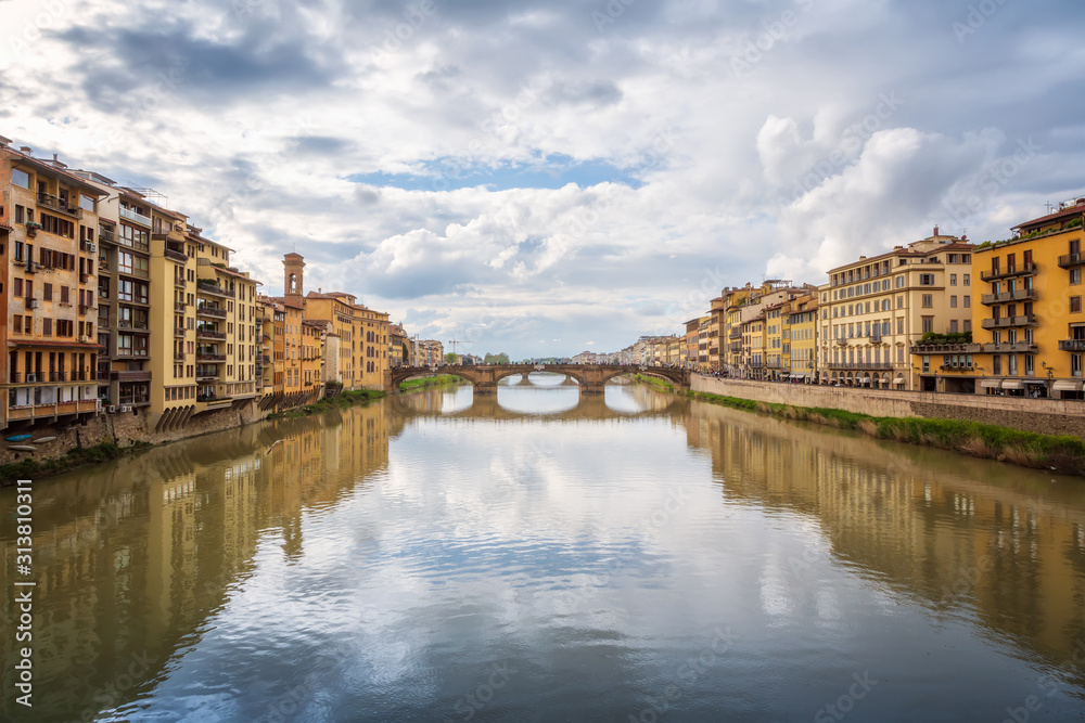 Panoramic day view of Ponte Santa Trinita (Holy Trinity Bridge) over Arno River in Florence, Italy.