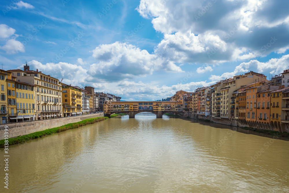 Panoramic day view of famous Ponte Vecchio over Arno River in Florence, Italy.
